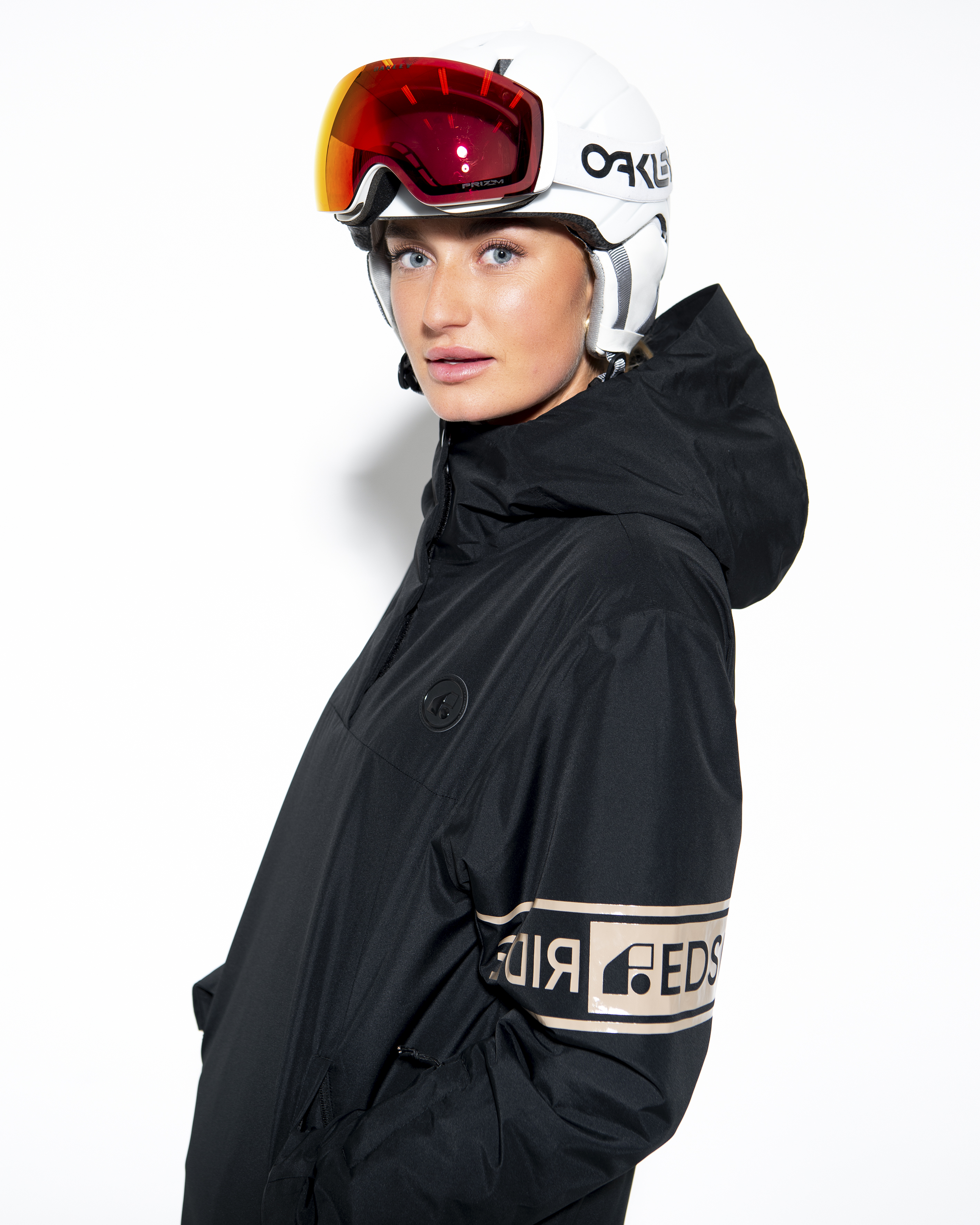 Lou black anorak, side view showing sleeve wordmark